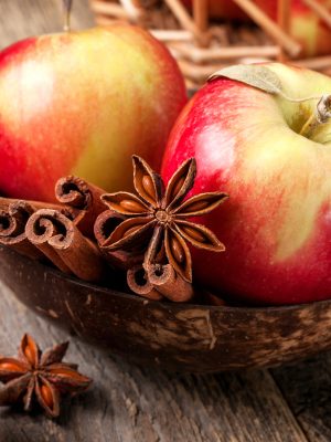 Apples with spices: cinnamon, star anise on a wooden background