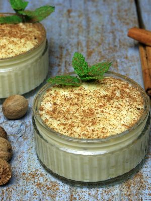 Ground Nutmeg And Cinnamon Sprinkled Over Thick Clotted Cream Rice Pudding.