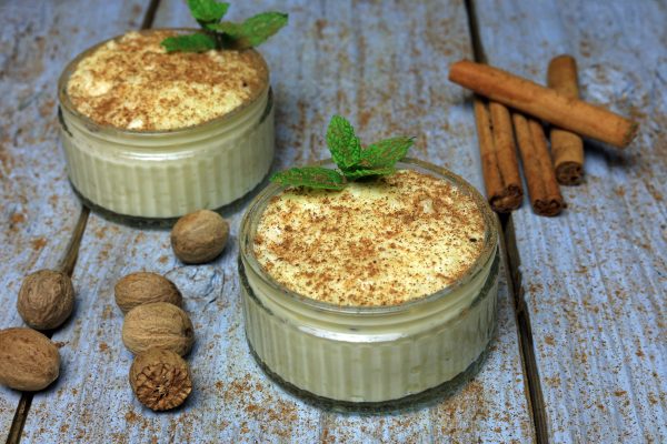 Ground Nutmeg And Cinnamon Sprinkled Over Thick Clotted Cream Rice Pudding.